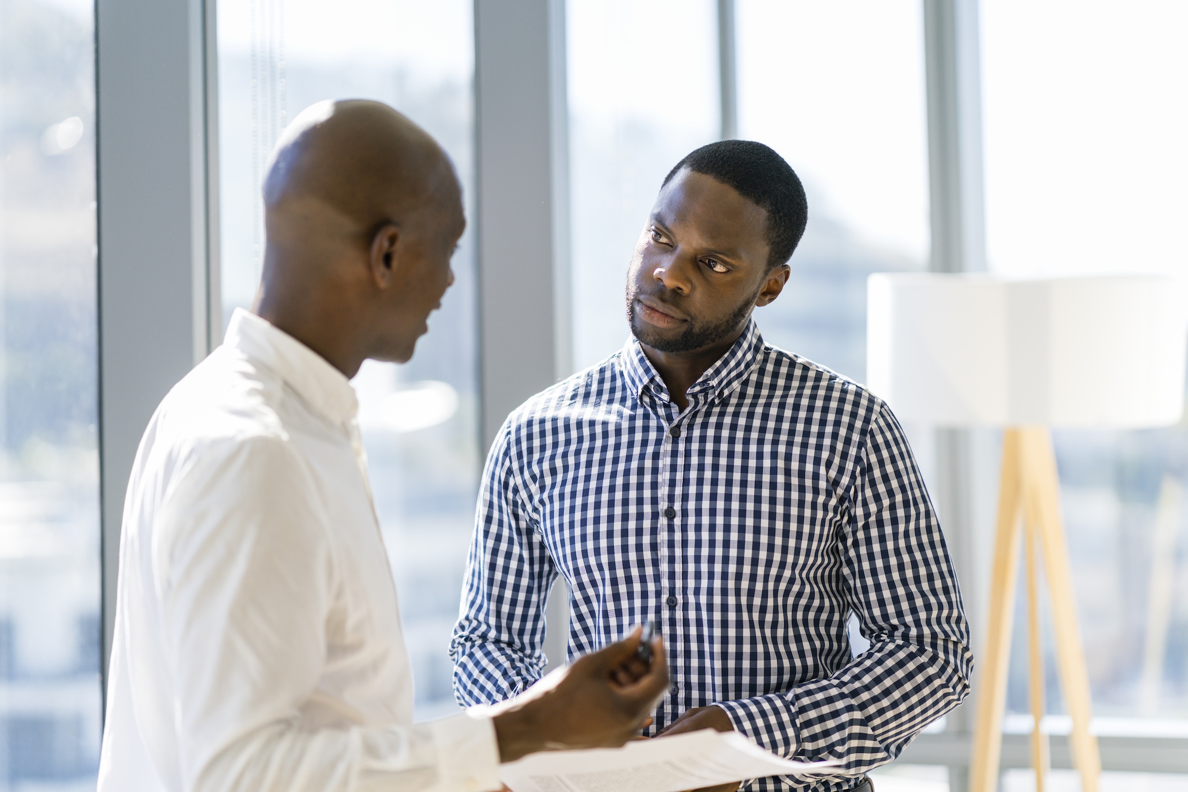 Formally-dressed men conversing